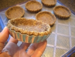 Nutty pie crust in mold with removable bottom